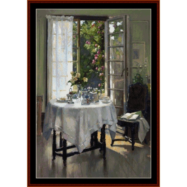 Counted Cross Stitch Pattern: Morning in the Studio by Patrick W. Adam - Cross Stitch Collectibles - A framed painting depicting a quiet interior scene with an open window, white tablecloth-covered table, flowers, a dark chair, and soft sunlight streaming in. The artwork is presented with a dark brown frame and black matting against a white background.