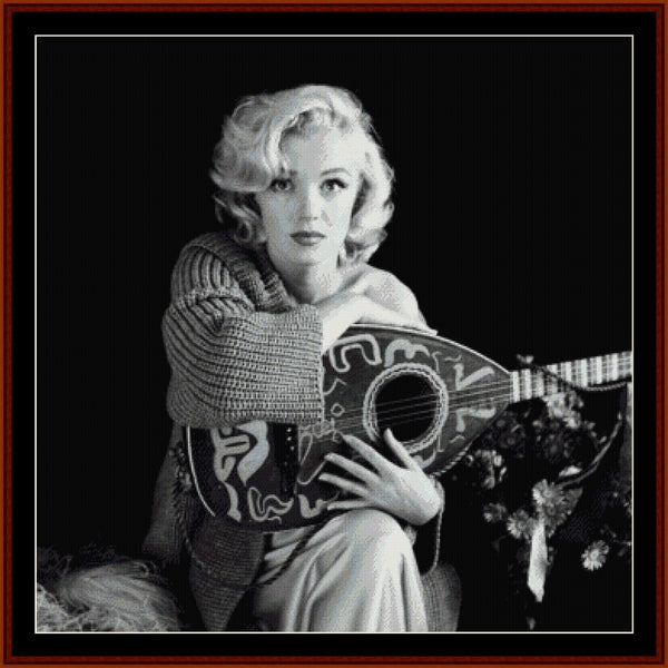 Counted Cross Stitch Pattern: Musical Marilyn Monroe - Cross Stitch Collectibles - Black and white portrait of a woman holding a decorative lute-like stringed instrument, framed by a dark border with a red inner frame.