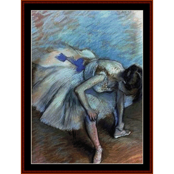 Counted Cross Stitch Pattern – Seated Dancer by Edgar Degas - Cross Stitch Collectibles - A framed pastel-style artwork depicting a ballerina in a white tutu leaning forward, with a blue dress accent and a dark brown floor.