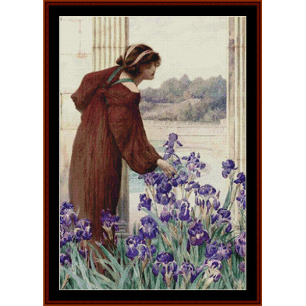 Counted Cross Stitch Pattern by Cross Stitch Collectibles -Woman in a brown dress standing by a window with purple flowers in the foreground