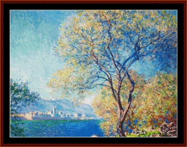 Counted Cross Stitch Pattern by Cross Stitch Collectibles depicting a landscape with a tree in the foreground and a cityscape in the background, reminiscent of Claude Monet's style.
