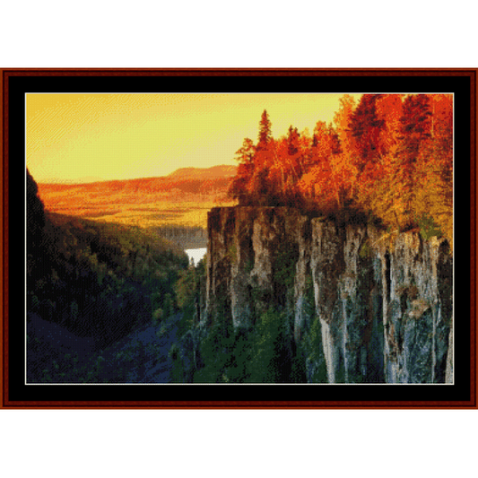 Counted Cross Stitch Pattern by Cross Stitch Collectibles depicting a scenic view with autumn-colored trees on a cliff edge.
