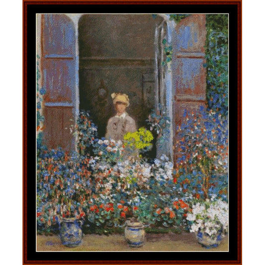 Counted Cross Stitch Pattern by Cross Stitch Collectiblesof a woman standing behind a floral arrangement with a garden view.