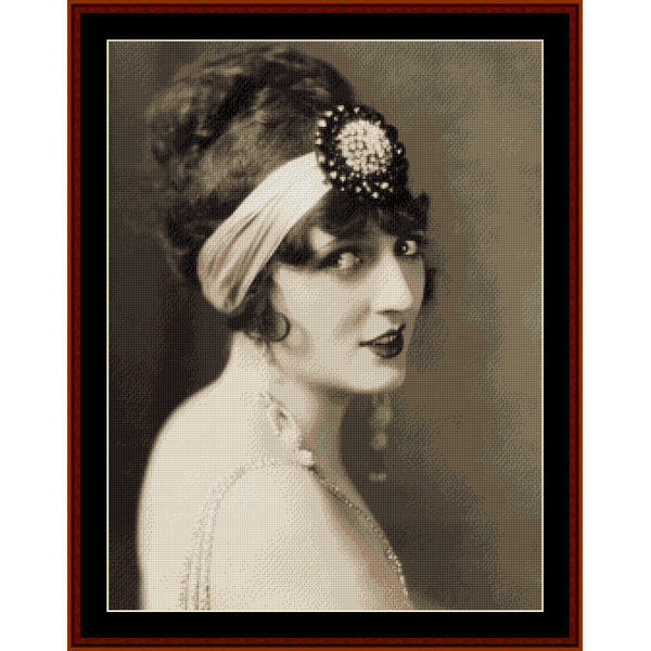 A vintage Counted Cross Stitch Pattern by Cross Stitch Collectibles depicting a portrait of a woman with a decorative headband.