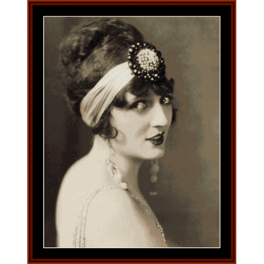 A vintage Counted Cross Stitch Pattern by Cross Stitch Collectibles depicting a portrait of a woman with a decorative headband.
