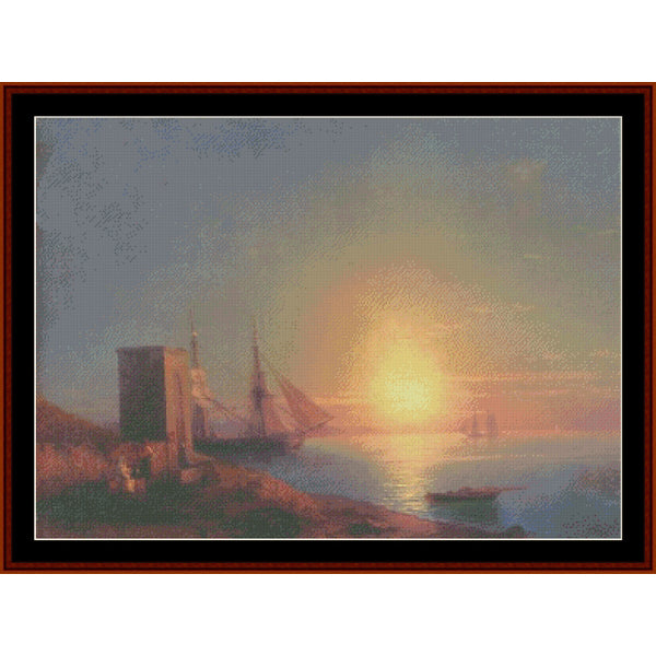 Counted Cross Stitch Pattern – Coastal Landscape at Sunset by Ivan Aivazovsky - Cross Stitch Collectibles - A framed seascape artwork showing a sunset over calm water with a large sailing ship, a small boat, and a rocky shoreline with a tower on the left.