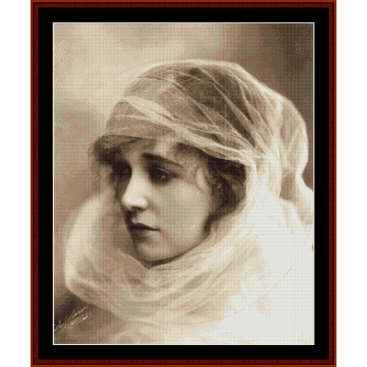 A vintage portrait Counted Cross Stitch Pattern by Cross Stitch Collectibles  picture, framed, featuring a woman with a veil over her head.