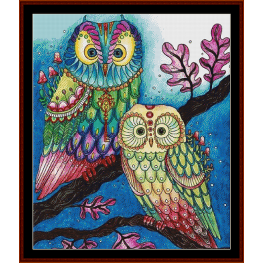Counted Cross Stitch Pattern by Cross Stitch Collectibles of two fantasy owls perched on a branch with a mystical background.