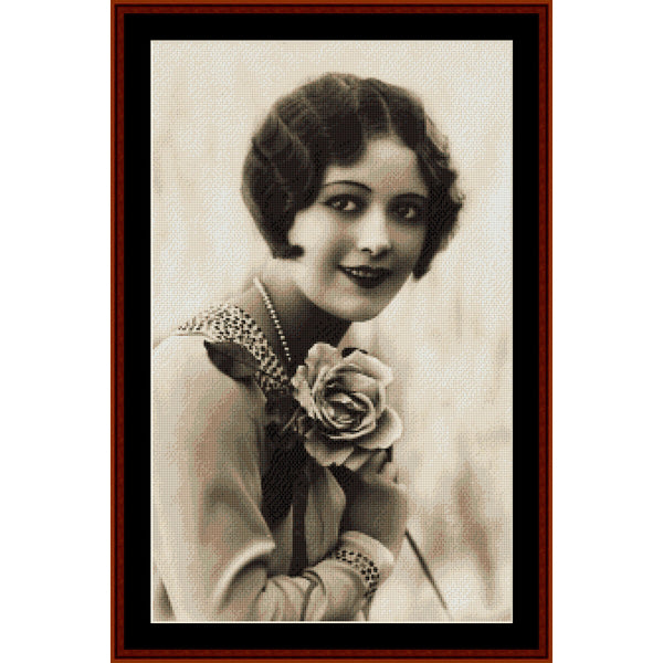 Vintage-style portrait Counted Cross Stitch Pattern by Cross Stitch Collectibles of a woman holding a rose, framed in brown.
