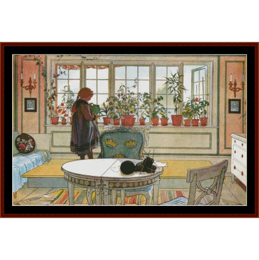 Colorful Counted Cross Stitch Pattern by Cross Stitch Collectibles of a room with a person standing by a window filled with potted plants.