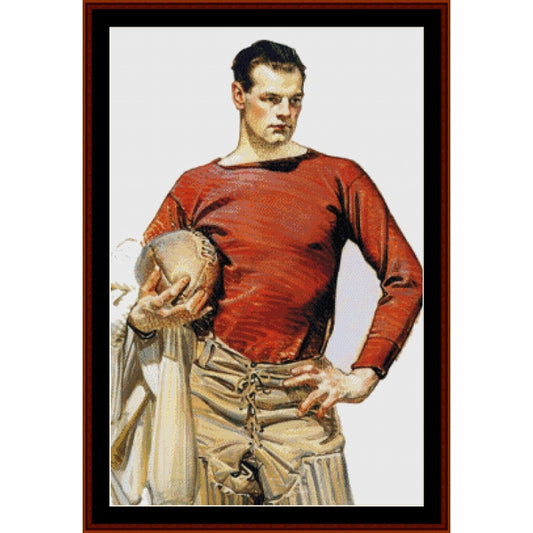Counted Cross Stitch Pattern by Cross Stitch Collectiblesof a football player in a red jersey and beige pants holding a football.