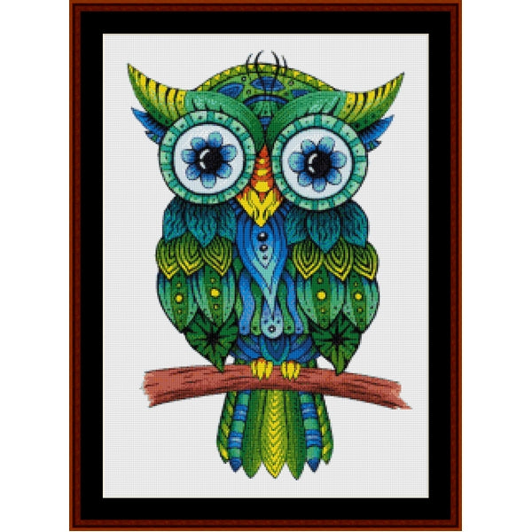Colorful owl Counted Cross Stitch Pattern by Cross Stitch Collectibles on a white background with a wooden frame.