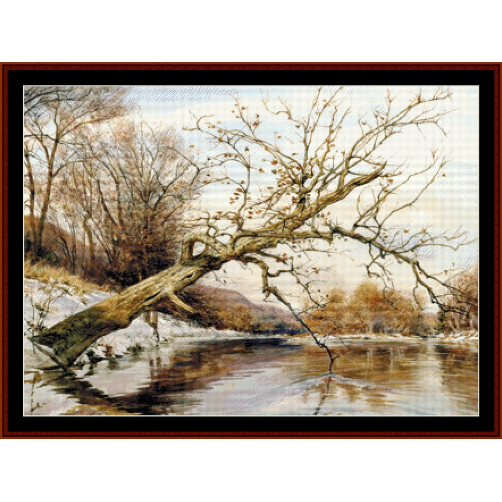 Counted Cross Stitch Pattern by Cross Stitch Collectibles  of a winter landscape with a fallen tree over a frozen river.