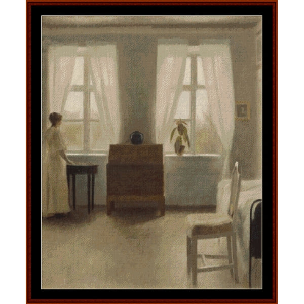 Counted Cross Stitch Pattern by Cross Stitch Collectibles of a room with large windows, furniture, and a person sitting.