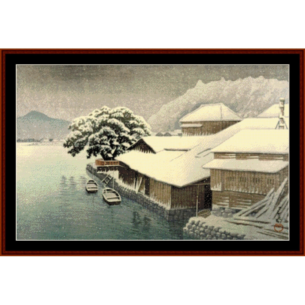 Counted Cross Stitch Pattern by Cross Stitch Collectibles of a snowy landscape with houses and trees.