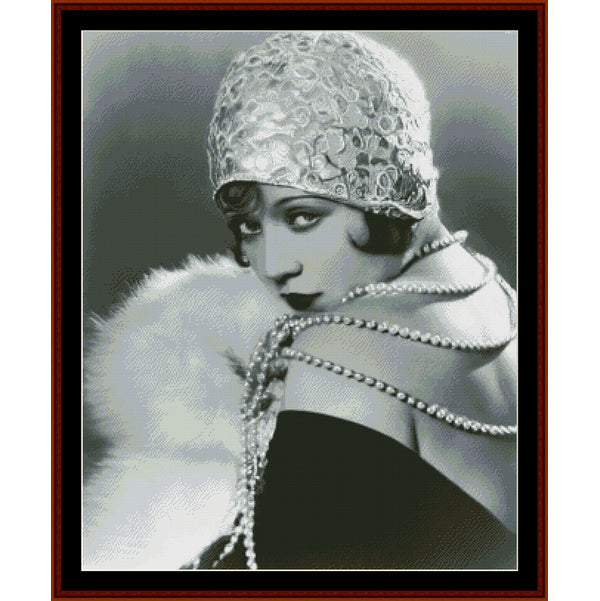 Counted Cross Stitch Pattern – Marie Provost, Vintage Portrait - Cross Stitch Collectibles - A framed black and white portrait print of a 1920s flapper woman wearing a textured beaded cap, pearl necklaces, and a white fur collar, with a dark dress