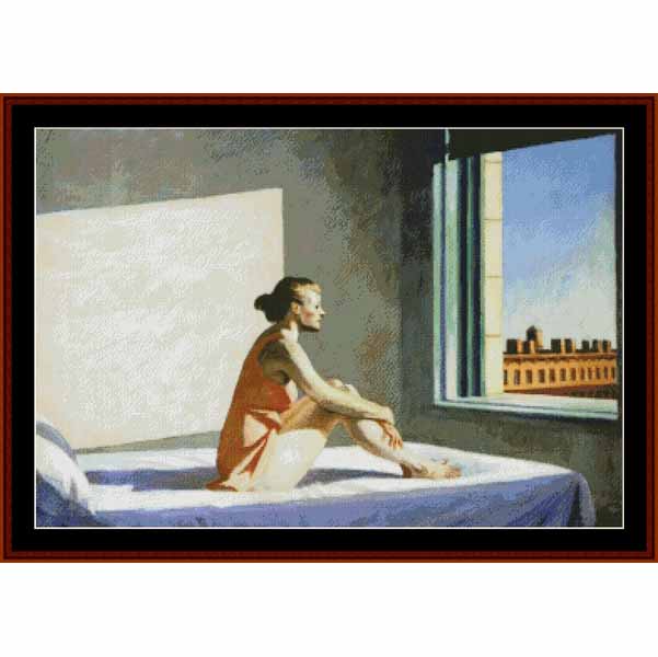 Counted Cross Stitch Pattern: Morning Sun by Edward Hopper - Cross Stitch Collectibles - A framed art print depicting a woman sitting on a bed in a room, looking out a window at a city building under a blue sky. The artwork is presented with a dark red-brown frame and white matting.