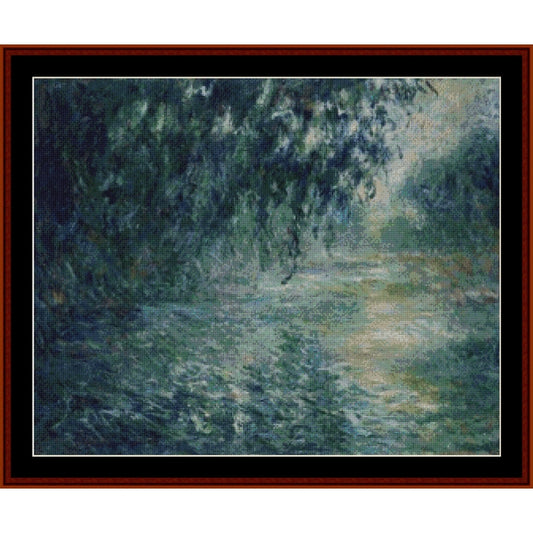 Counted Cross Stitch Pattern: Morning on the Seine VIII by Claude Monet- Cross Stitch Collectibles - Impressionist-style landscape painting of a tree-lined path or river, shown within a black mat and dark reddish-brown wooden frame. The artwork features blue-green foliage and a soft light pathway through the scene.