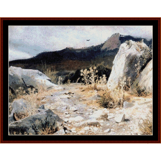Counted Cross Stitch Pattern: Mountain Path by Ivan Shishkin - Cross Stitch Collectibles - A framed landscape painting depicting a rocky, dry mountain path with sparse vegetation under a pale sky, bordered by a black mat and dark reddish-brown frame.