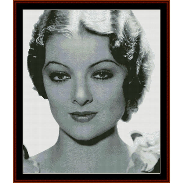 Counted Cross Stitch Pattern: Myrna Loy, Vintage Celebrity - Cross Stitch Collectibles - A framed black and white portrait print of a woman with short curled hair, shown against a white background 