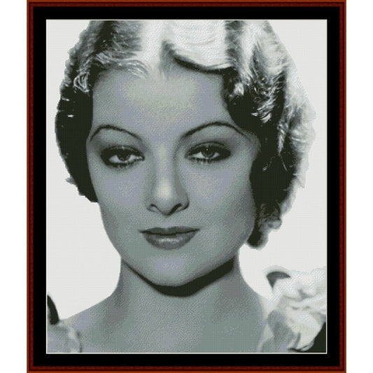 Counted Cross Stitch Pattern: Myrna Loy, Vintage Celebrity - Cross Stitch Collectibles - A framed black and white portrait print of a woman with short curled hair, shown against a white background 