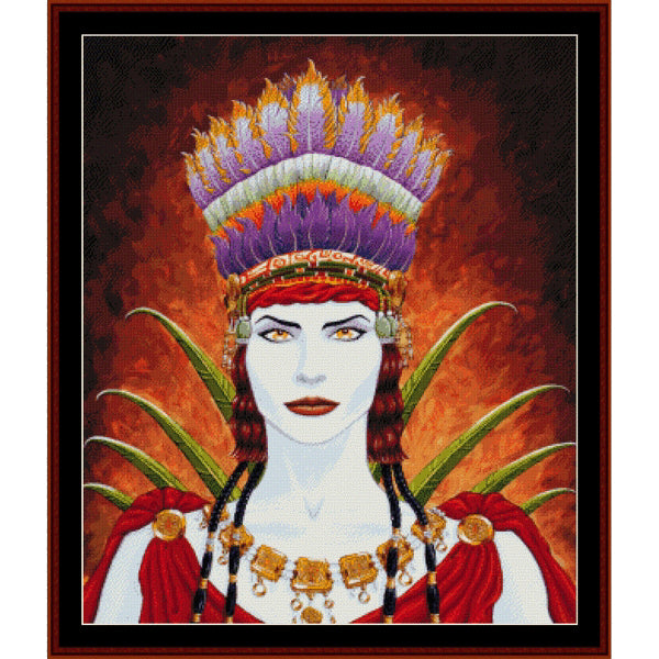 Counted Cross Stitch Pattern: Nasca Woman, Fantasy - Cross Stitch Collectibles - A framed portrait-style artwork showing a woman with pale skin, red lips, a large multicolored feathered headdress, green leaf-like elements behind her, and red draped clothing against a fiery orange-brown background.