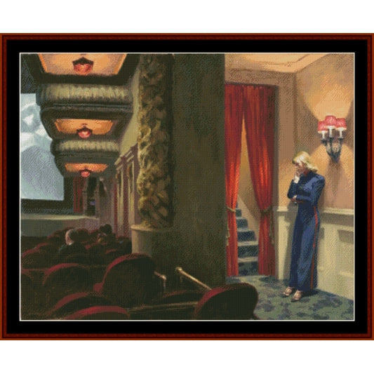 Counted Cross Stitch Pattern: New York Movie by Edward Hopper - Cross Stitch Collectibles - A framed painting depicting an interior theater scene with red curtains, red seats, a woman in a blue dress standing by the stairs, and warm hanging lights.