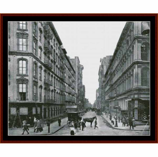 Counted Cross Stitch Pattern: New York Street Scene, 1910 - Cross Stitch Collectibles - A framed black and white historical photograph print depicting a bustling city street with pedestrians, horse-drawn carriages, and tall urban buildings
