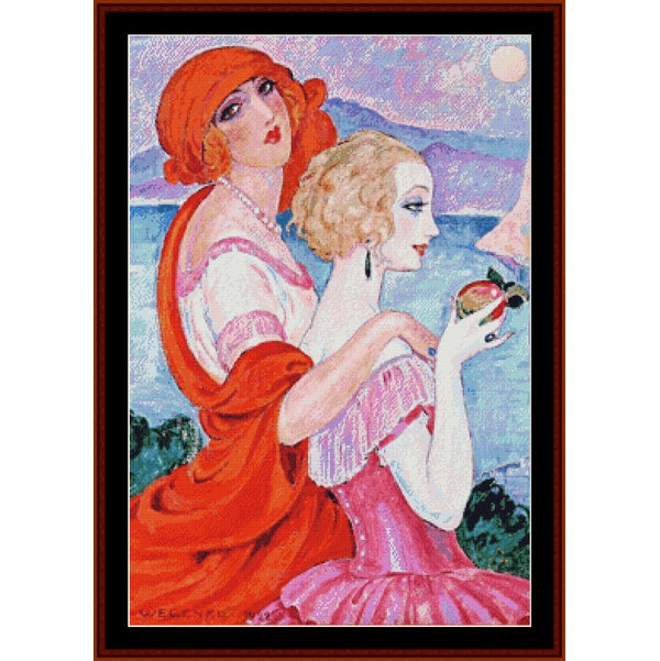 Counted Cross Stitch Pattern: On the Road to Ana Capri by Gerda Wegener - Cross Stitch Collectibles - A framed art print featuring a vintage-style illustration of two women by the sea. One woman wears a bright red headscarf and red draped dress, while the other has blonde hair and wears a pink dress.