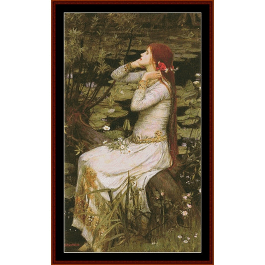 Counted Cross Stitch Pattern: Ophelia by J.W. Waterhouse - Cross Stitch Collectibles - A framed art print depicting a woman in a white dress sitting by a pond with lily pads and reeds, wearing a red flower in her hair.
