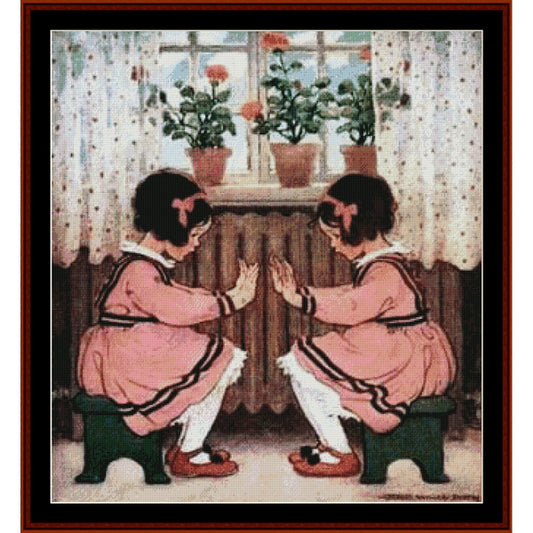 Counted Cross Stitch Pattern: Pat-a-Cake by Jesse Willcox Smith - Cross Stitch Collectibles - A framed vintage-style illustration showing two young girls in pink dresses sitting on stools and facing each other with open hands, set in a room with curtains, potted flowers, and a window.