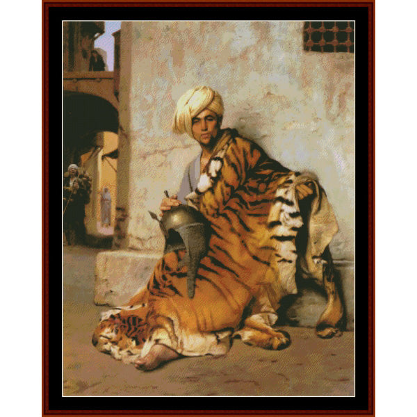 Counted Cross Stitch Pattern: Pelt Merchant of Cairo by J. L. Gerome - Cross Stitch Collectibles - A framed painting depicting a man in a white turban seated on a tiger, with another tiger lying beside him, set against a textured beige wall in an architectural scene.