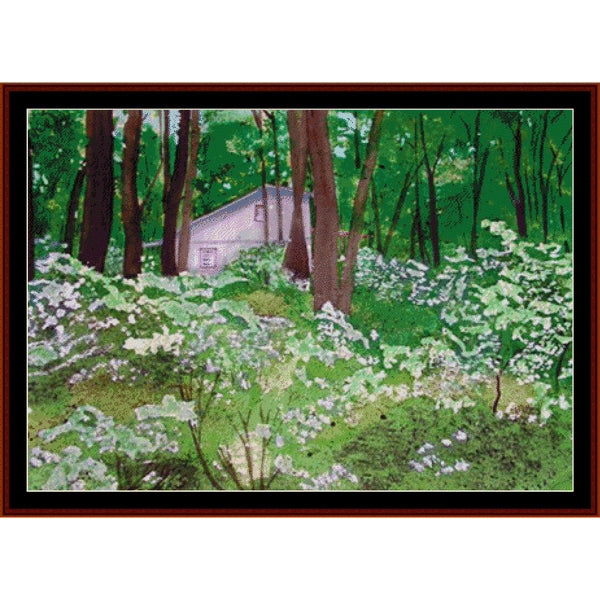 Counted Cross Stitch Pattern: Pennsylvania Cabin - Cross Stitch Collectibles - A framed landscape painting depicting a small white cabin nestled among tall green trees and dense white flowers in a forest clearing