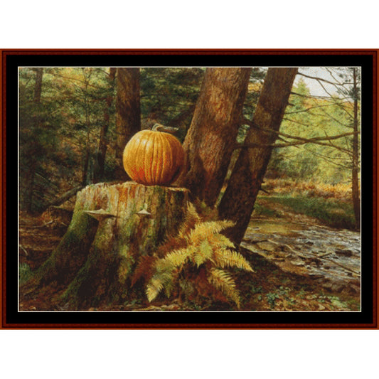Counted Cross Stitch Pattern – Pumpkin Pines, Americana - Cross Stitch Collectibles - A framed landscape painting depicting an orange pumpkin resting on a mossy tree stump in a forest, with ferns and a stream in the foreground