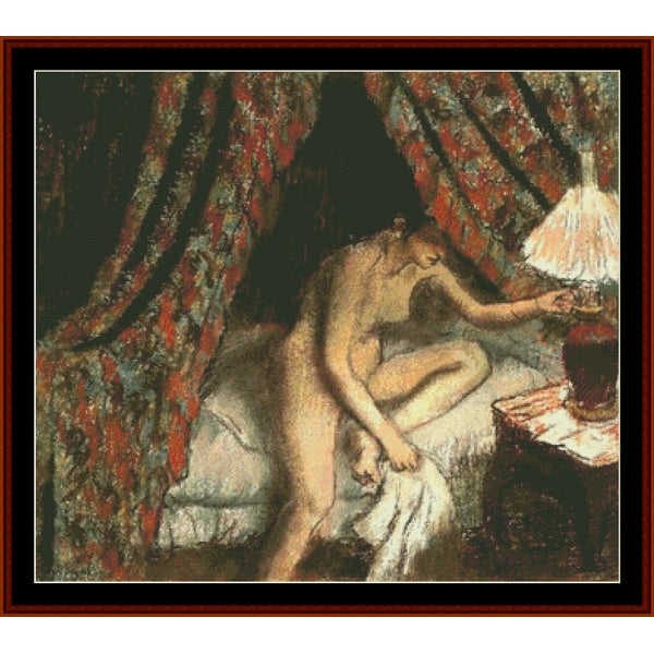 Counted Cross Stitch Pattern – Retiring by Edgar Degas - Cross Stitch Collectibles - A framed classical painting depicting a reclining nude woman on a bed beside a lit table lamp, with patterned red and green drapery in the background.