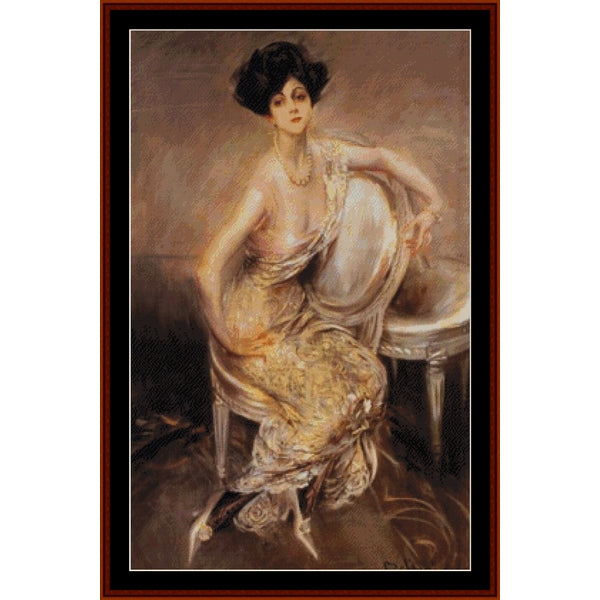 Counted Cross Stitch Pattern – Rita Lydig by Giovanni Boldini - Cross Stitch Collectibles - A framed vintage-style portrait painting of a seated woman in a flowing pale gold and white dress