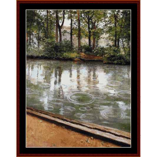 Counted Cross Stitch Pattern – Riverbank in the Rain by Gustave Caillebotte - Cross Stitch Collectibles - A framed landscape art print depicting a calm lake with raindrop ripples, trees, and a sandy shore