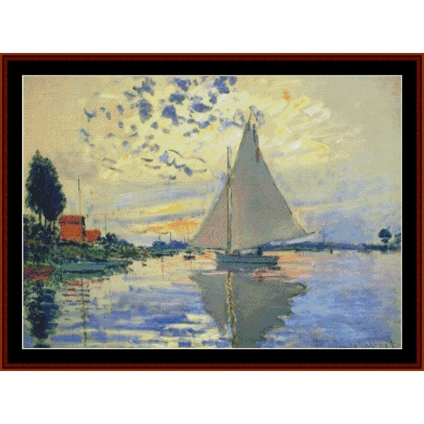 Counted Cross Stitch Pattern – Sailboat at Le Petit-Gennevilliers by Claude Monet - Cross Stitch Collectibles - A framed impressionist-style painting depicting a sailboat on calm water under a cloudy sky, with trees and a red-roofed building on the left.background.