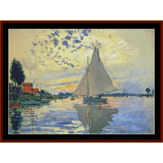 Counted Cross Stitch Pattern – Sailboat at Le Petit-Gennevilliers by Claude Monet - Cross Stitch Collectibles - A framed impressionist-style painting depicting a sailboat on calm water under a cloudy sky, with trees and a red-roofed building on the left.background.