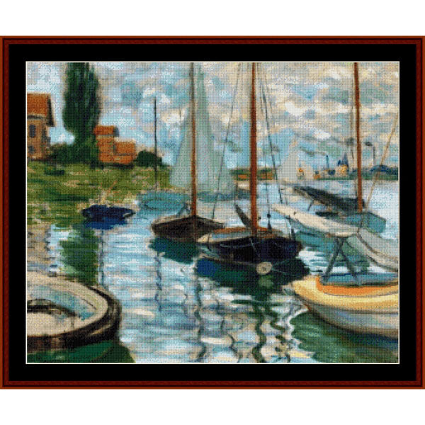 Counted Cross Stitch Pattern – Sailboats on the Seine at Petit Gennevilliers by Claude Monet - Cross Stitch Collectibles - A framed impressionist-style painting depicting several sailboats moored in calm water, with green shoreline, small buildings, and a cloudy sky. 