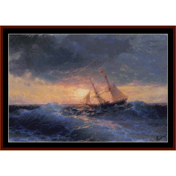 Counted Cross Stitch Pattern – Sea Sunset, 1896 by Ivan Aivazovsky - Cross Stitch Collectibles - A framed seascape painting showing a sailing ship navigating dark blue waves under a dramatic cloudy sky with warm light near the horizon.