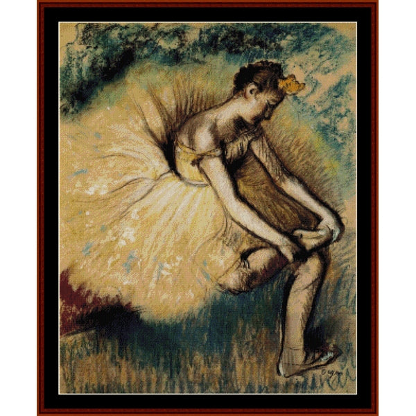 Counted Cross Stitch Pattern – Seated Dancer II by Edgar Degas - Cross Stitch Collectibles - A framed art print featuring a pastel-style painting of a ballerina in a flowing cream tutu, seated and looking downward, with dark green and blue brushstrokes in the background 