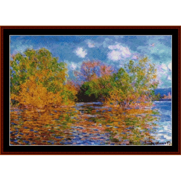 Counted Cross Stitch Pattern – Seine Near Giverny by Claude Monet - Cross Stitch Collectibles - A framed impressionist landscape painting depicting trees with yellow, green, and orange foliage reflected in blue water under a cloudy sky